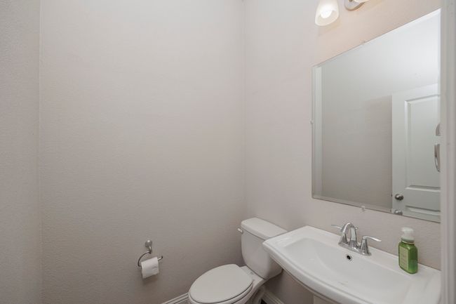 Bathroom featuring a sink and toilet | Image 15