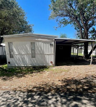 Cabin #32 is just a block from the swim cove! Covered front deck is ideal for outdoor relaxation; new mini-split AC unit | Image 2