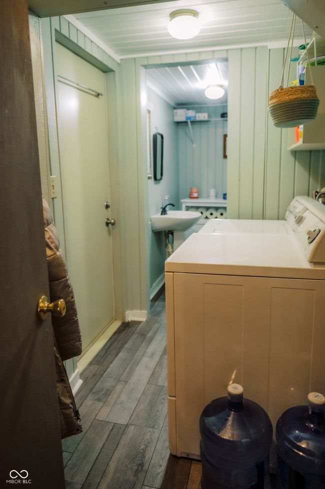 clothes washing area with laundry area, dark wood-style flooring, a sink, and washing machine and dryer | Image 17