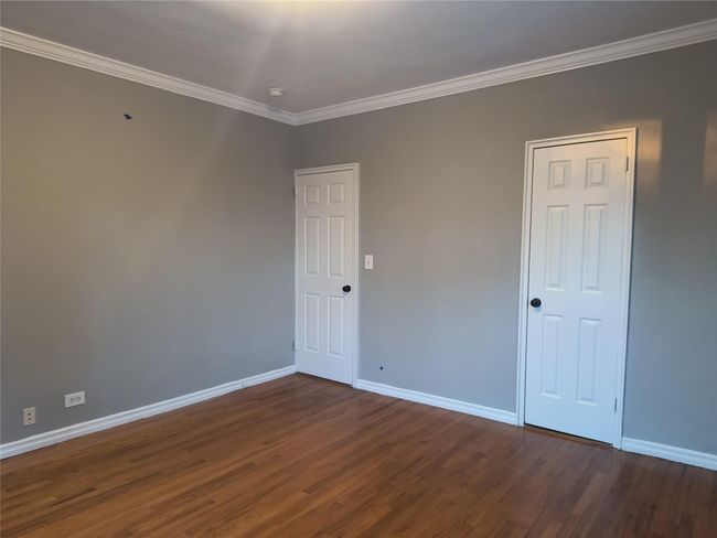 Empty room featuring crown molding, baseboards, and wood finished floors | Image 35