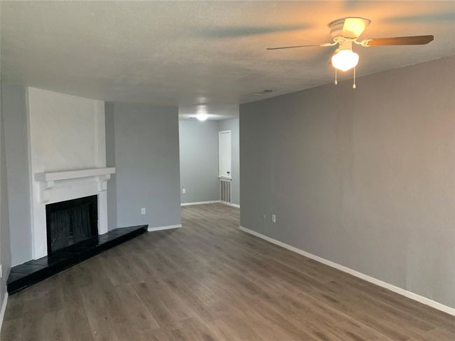 Unfurnished living room with ceiling fan and hardwood / wood-style floors | Image 4