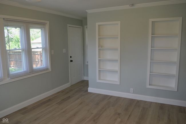 Dining room with built in shelves, and ornamental molding | Image 19