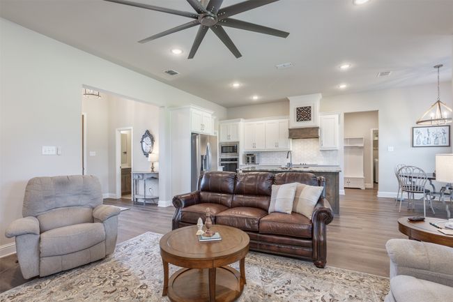Living space back to the half bath and the laundry room. | Image 15