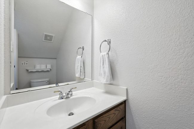 Bathroom with vanity and a textured wall | Image 18