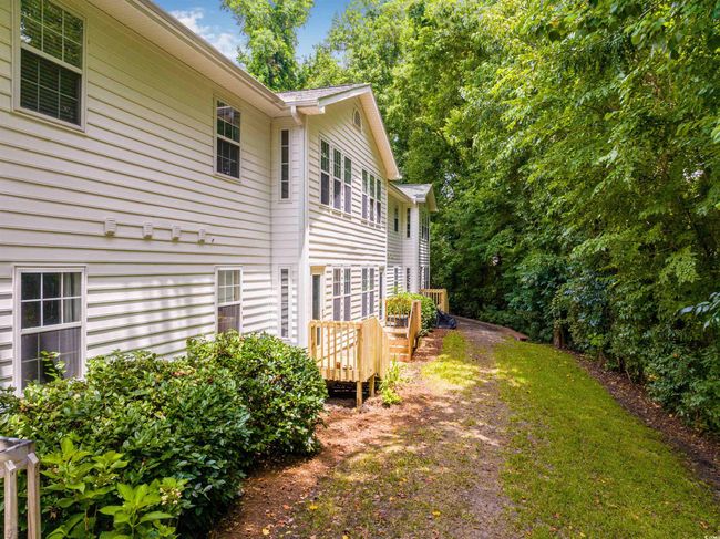 View of home's exterior featuring driveway and a wooden deck | Image 38