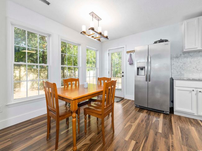 Dining space featuring baseboards, dark wood finished floors, and a notable chandelier | Image 13