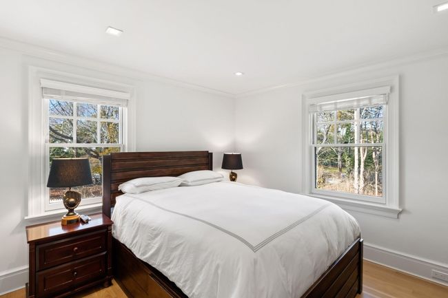 Bedroom featuring multiple windows, light hardwood / wood-style flooring, and ornamental molding | Image 34