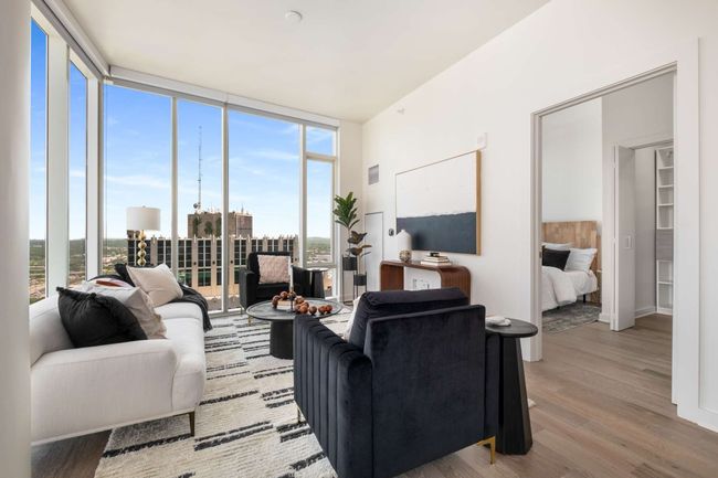 Surrounded by two walls of floor-to-ceiling windows, the living space is as inviting as it is beautiful. | Image 20