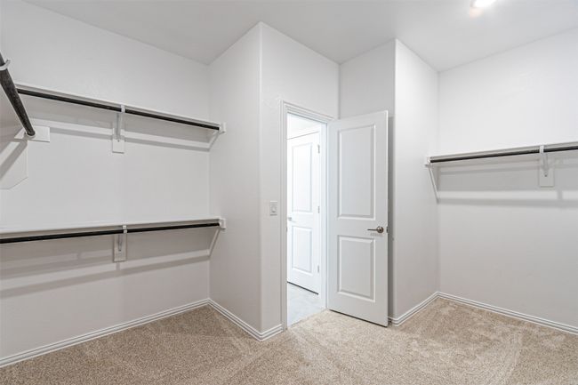 Spacious closet with light colored carpet | Image 29