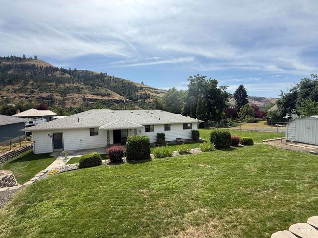 Back of house with a storage unit and a mountain view | Image 5