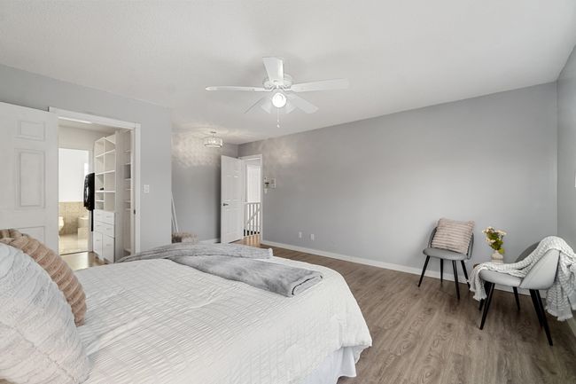 Bedroom with a ceiling fan, baseboards, wood finished floors, and ensuite bathroom | Image 21