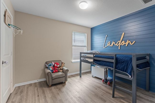 Bedroom featuring wood finished floors and baseboards | Image 20