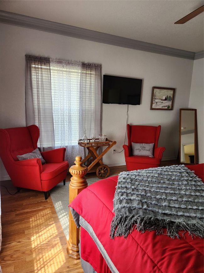 Bedroom with ornamental molding and wood finished floors | Image 7