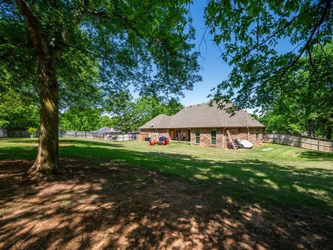 Rear view of property featuring a lawn and a fenced backyard | Image 36