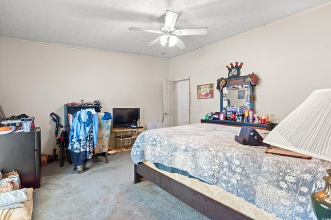 Carpeted bedroom featuring a textured ceiling and ceiling fan | Image 26