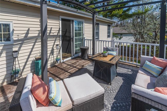 View of patio featuring a wooden deck, outdoor lounge area, and a pergola | Image 24