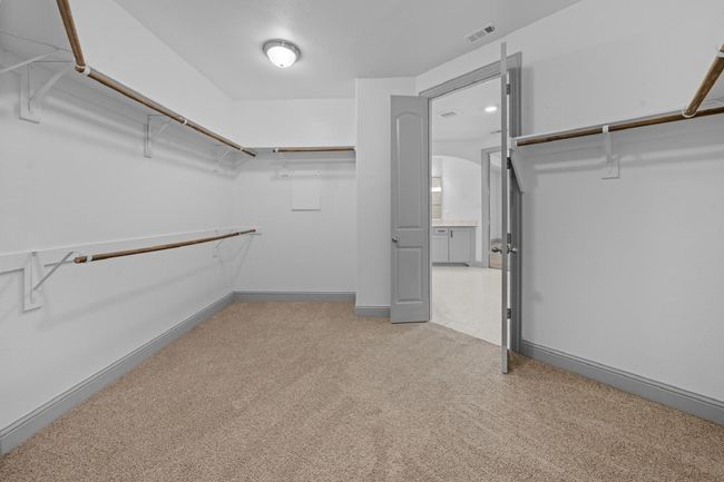 Walk in closet featuring carpet floors and visible vents | Image 15