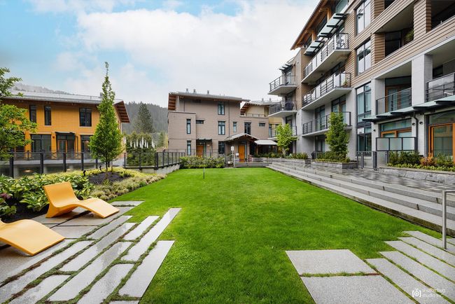View of property's community with a lawn and fence | Image 24