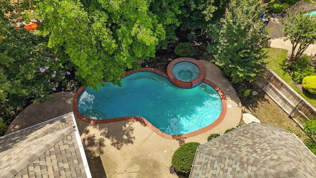 View of swimming pool featuring an in-ground hot tub, a fenced backyard, and a patio area | Image 29