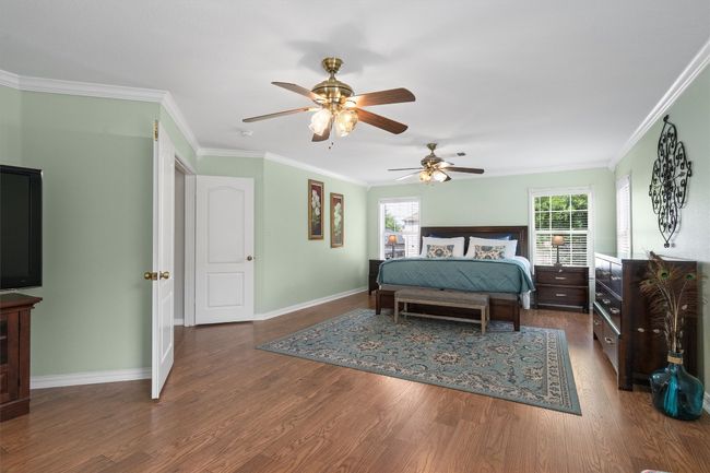 The Texas-sized primary suite is a true retreat with French door entry, crown molding, and sitting area. | Image 25