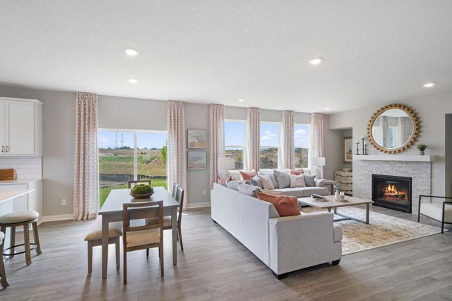 Natural light flows into this family room with cozy gas fireplace. Model photo. Options and colors will vary. | Image 7