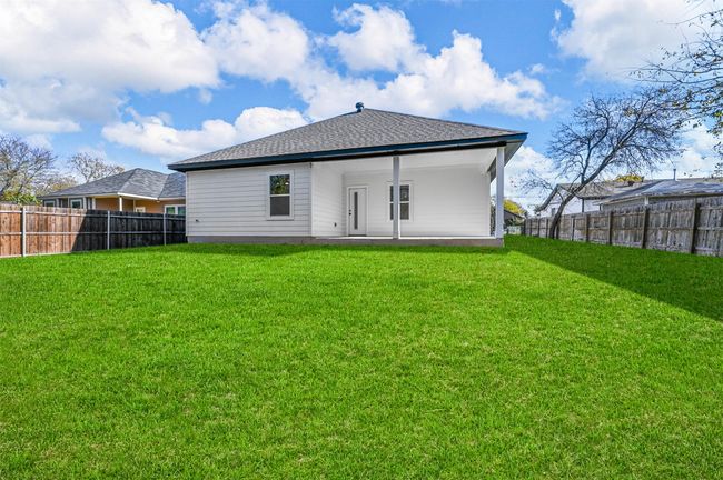 Back of property with roof with shingles, a yard, and a fenced backyard | Image 30