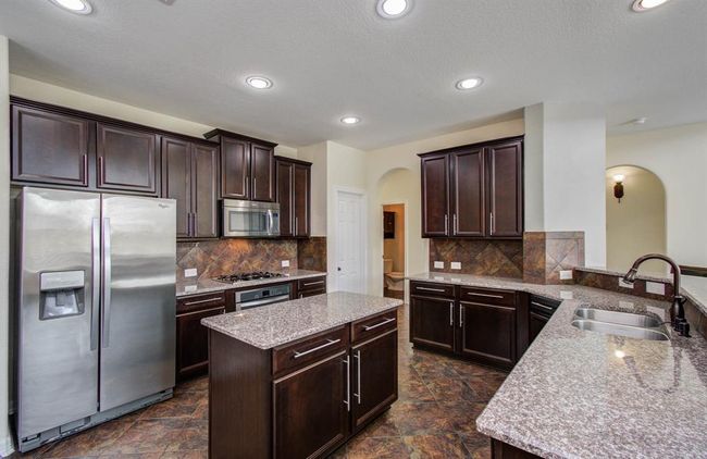 Large Kitchen with plenty of cabinets, island, granite counter tops and undermount sink. Refrigerator comes with lease. | Image 7
