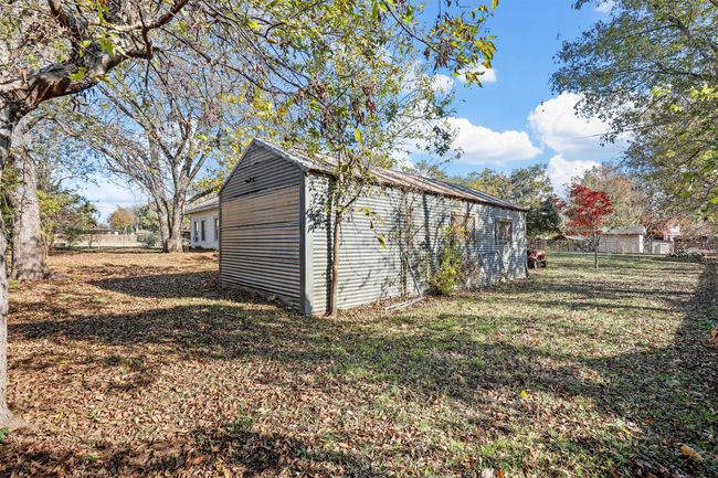 View of outbuilding with a lawn | Image 6
