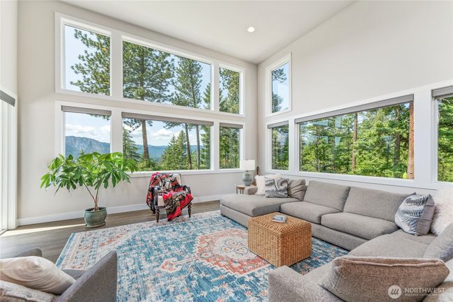 Soaring ceilings, abundant natural light, stunning views and seamless flow between the kitchen, dining, and living areas create a most elegant atmosphere | Image 14