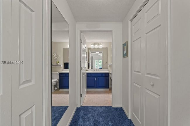 Spacious walk-in closet on right and entrance to primary bath. | Image 19