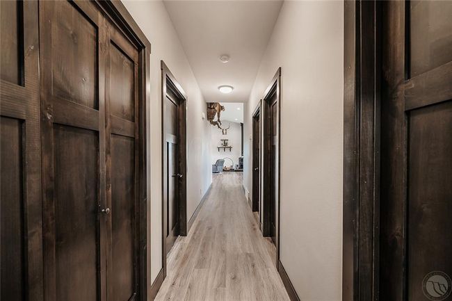 View from Laundry room down the 4' hall to Great room. Shows the gorgeous smoky black stained alder doors and trim. | Image 20