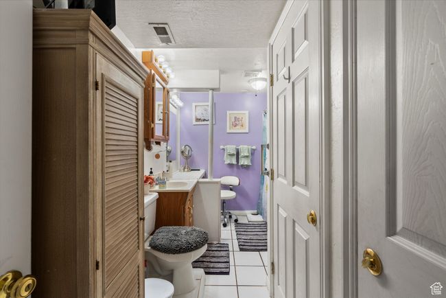 This bath has grab bars and a walk in tub for the older generation. along with a make up vanity and the utlitity area for the home | Image 29