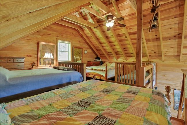 Bedroom with wood walls and wooden ceiling | Image 22