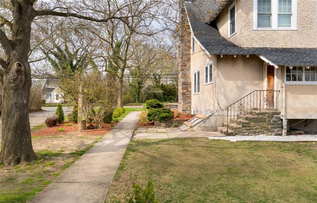 View of property exterior featuring a shingled roof and stucco siding | Image 17
