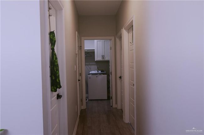 Corridor featuring washer / dryer and dark wood-style flooring | Image 17