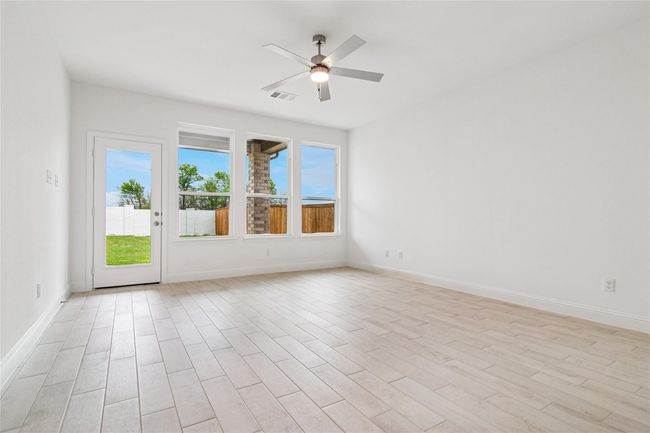 Spare room featuring light wood-style flooring and ceiling fan | Image 27