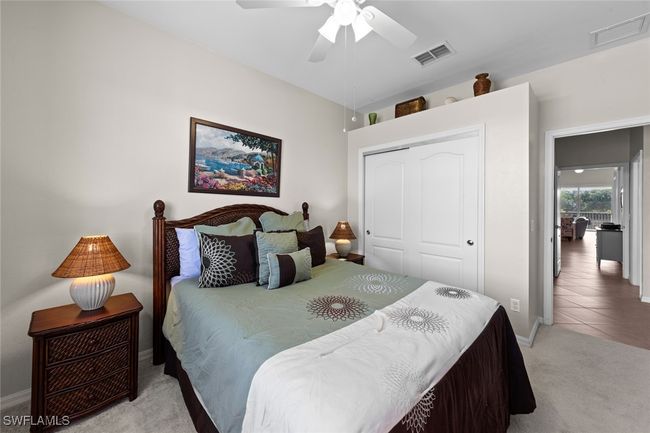 Bedroom featuring a closet, visible vents, baseboards, and light carpet | Image 19