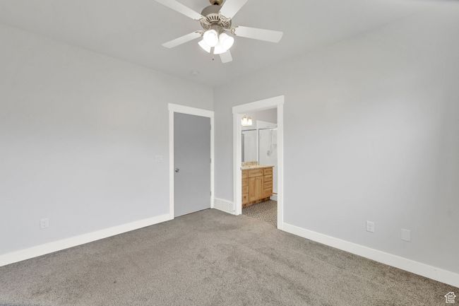 Carpeted spare room with a ceiling fan and baseboards | Image 52