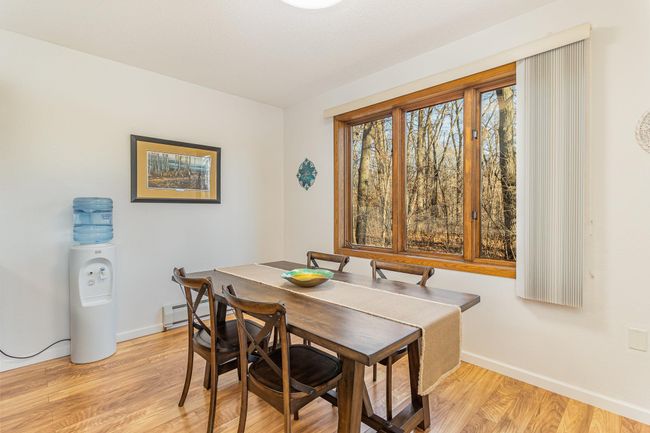 The informal dining room has ample space for a dining room set and hutch. Enjoy your meals with the views overlooking the wooded lot. | Image 19
