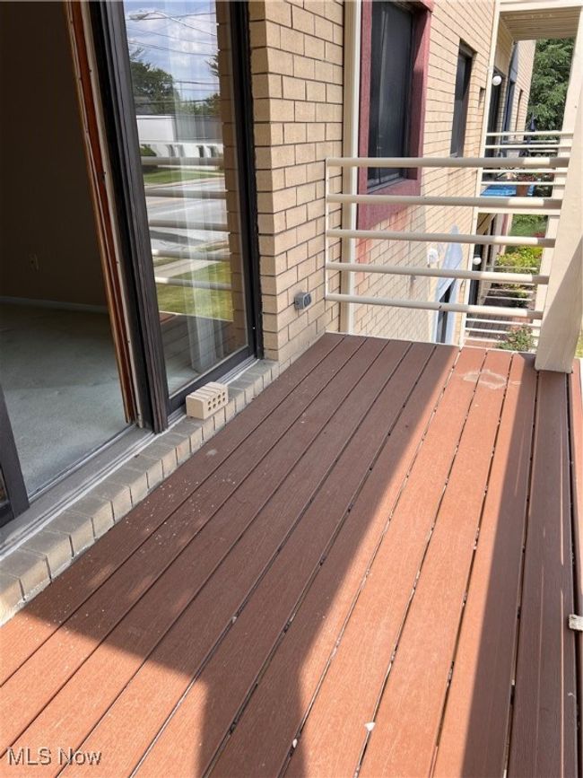 View of wooden deck off the living room. | Image 13