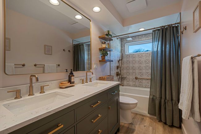 Full bathroom with shower / bath combo, hardwood / wood-style floors, vanity, and toilet | Image 10