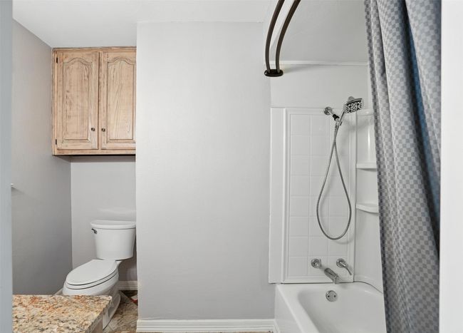 Full bathroom featuring toilet and shower / tub combo with curtain | Image 18