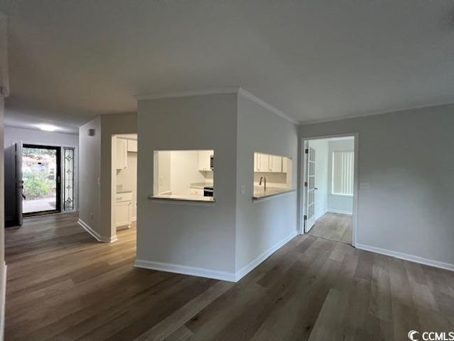 Corridor featuring dark wood-style flooring, baseboards, and ornamental molding | Image 28