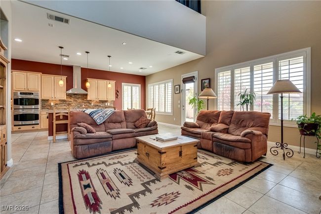 Living area featuring light tile patterned floors, baseboards, and visible vents | Image 30