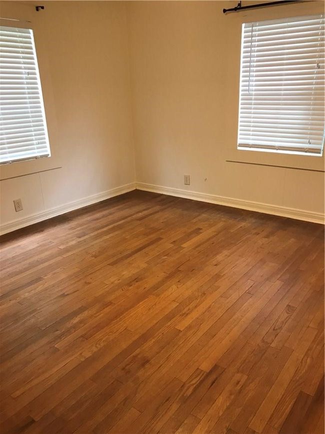 Empty room featuring dark wood-style floors and baseboards | Image 4