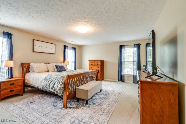Bedroom with light carpet and a textured ceiling | Image 22
