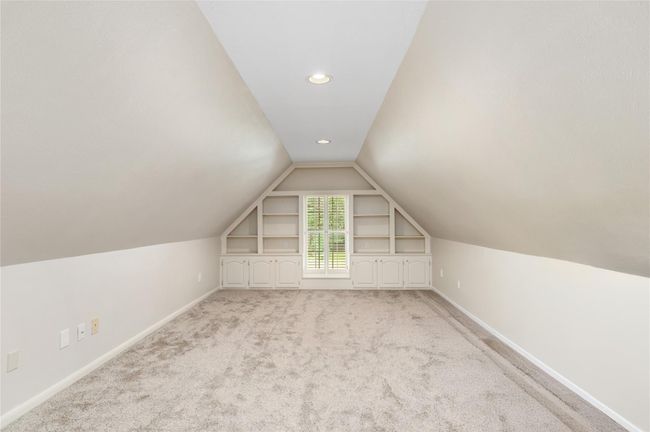 This large upstairs flex space offers endless possibilities—imagine a playroom, study, studio, or private suite. Built-ins and large windows make it as practical as it is versatile. | Image 32