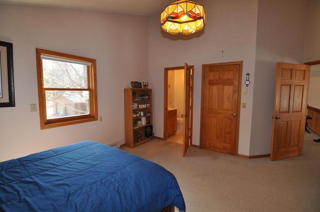 Upper level bedroom features a private 1/2 bath. | Image 38