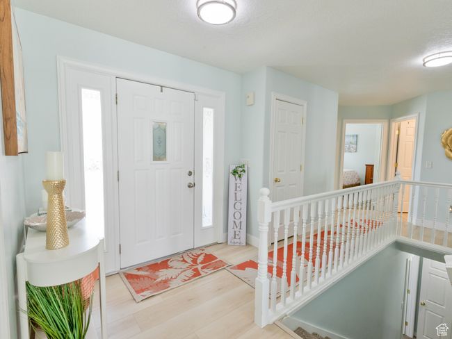 Foyer entrance with wood finished floors and healthy amount of natural light | Image 10