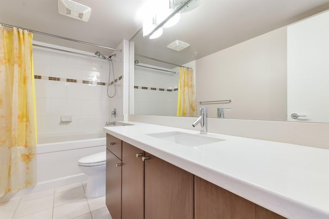 Full bath featuring tile patterned flooring, vanity, and shower / bathtub combination with curtain | Image 25